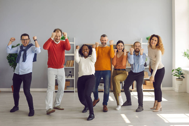 Team of happy excited diverse business people celebrating success and having fun - Fotoğraf, Görsel