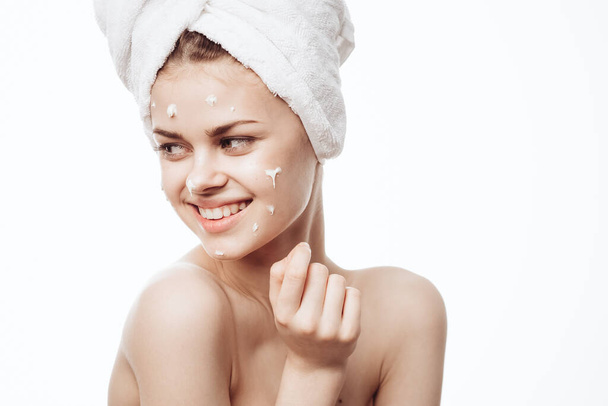 cheerful woman with a white towel on her head face cream skin care - Photo, Image