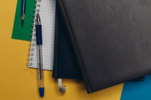 black notepad pencil colorful background office supplies - Valokuva, kuva
