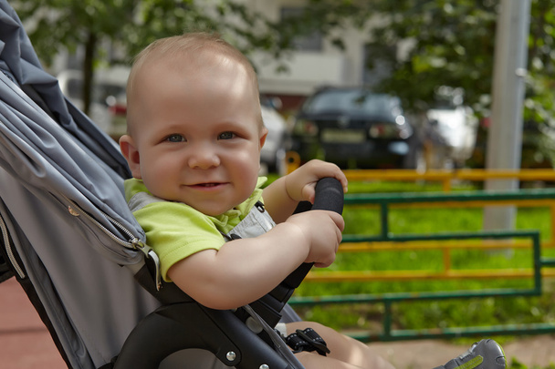 Adorable baby boy in a stoller - Foto, afbeelding