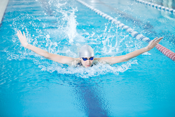 Girl swimming in butterfly stroke style - Foto, Imagem