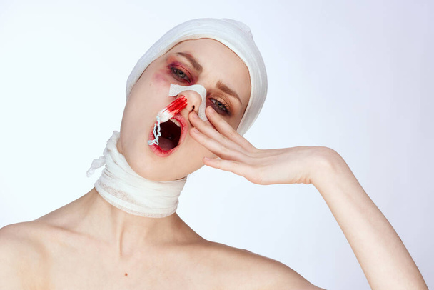 a person tampon in the nose with blood injured face isolated background - 写真・画像