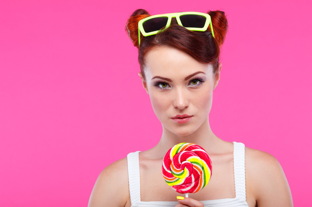 Redheaded girl with candy - Фото, изображение