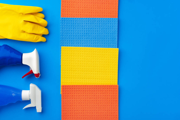 House cleaning supplies on blue color background - Fotoğraf, Görsel