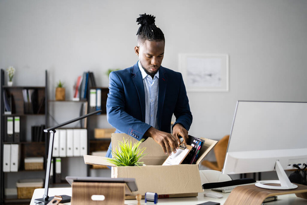 Job Quit. Employee Holding Cardboard Box At Desk - Foto, Bild