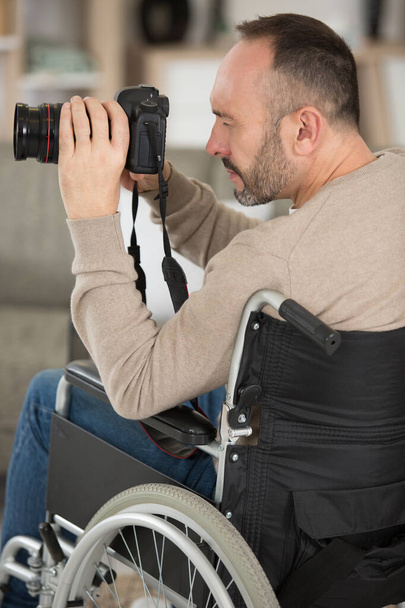 disable man with a camera on a selfie stick - Foto, Imagen