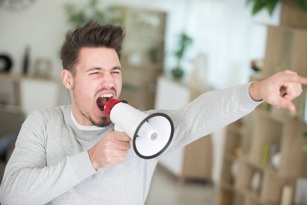 young man shouting on horn loudspeaker - Photo, Image