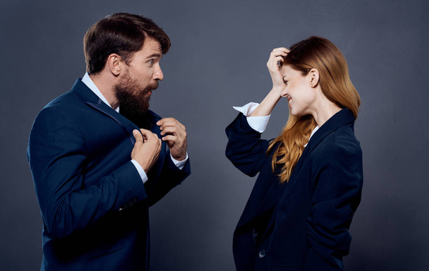 cheerful man and woman work colleagues team dark background - Foto, afbeelding