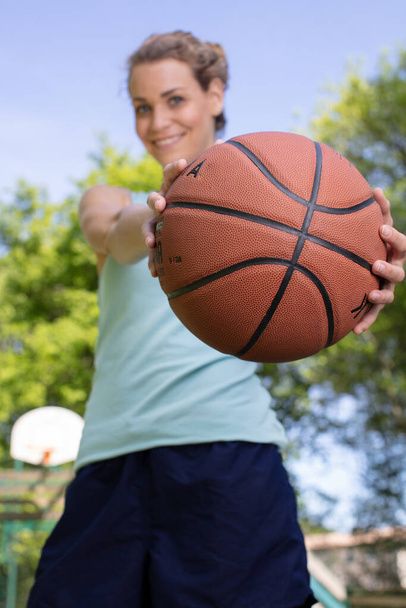 portrait of young female basketball player passing the ball - Фото, зображення