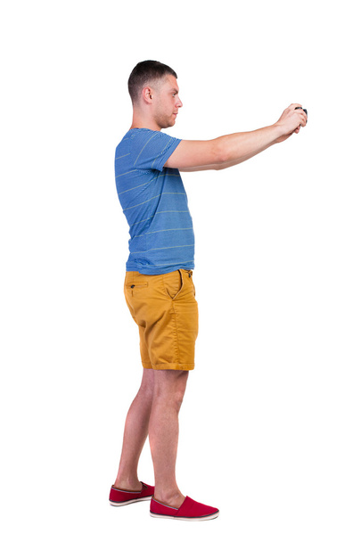Back view of man photographing.  tourist in shorts. - Φωτογραφία, εικόνα