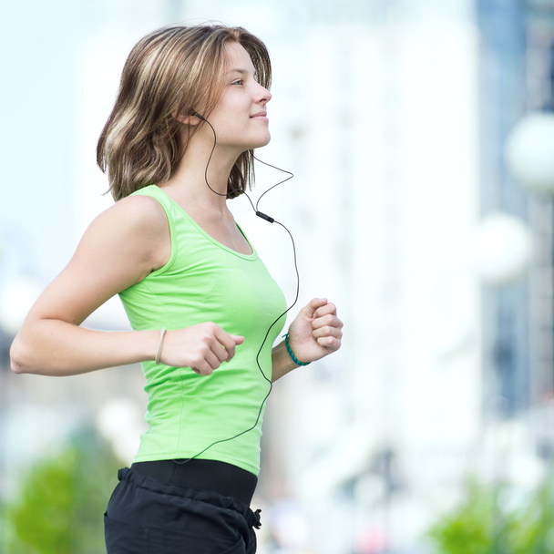 Woman jogging in city street park. - Фото, зображення