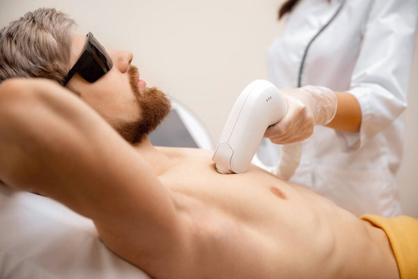 Man torso hair removal laser epilation studio - 写真・画像