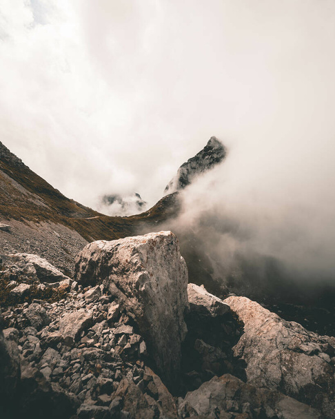 A mesmerizing view of beautiful Swiss mountains under the clouds on a gloomy day - 写真・画像