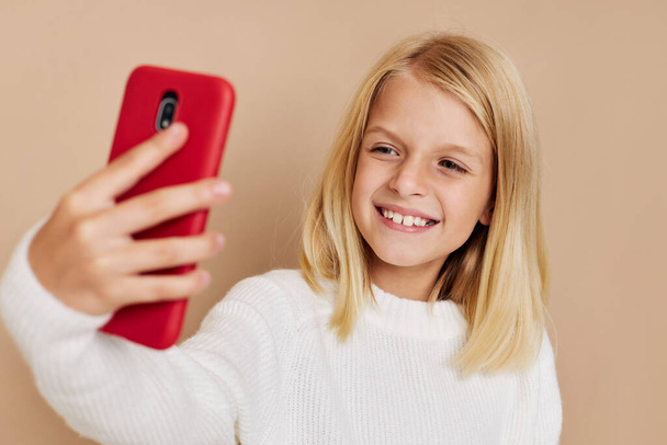 Positive little girl with  smartphone  concept. High quality photo - Photo, Image