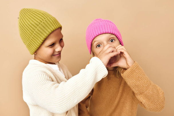 boy and girl on  beige background. High quality photo - Photo, image