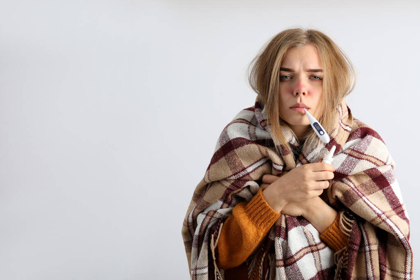 Nemocná mladá žena na světlém pozadí, sezónní chladný koncept - Fotografie, Obrázek