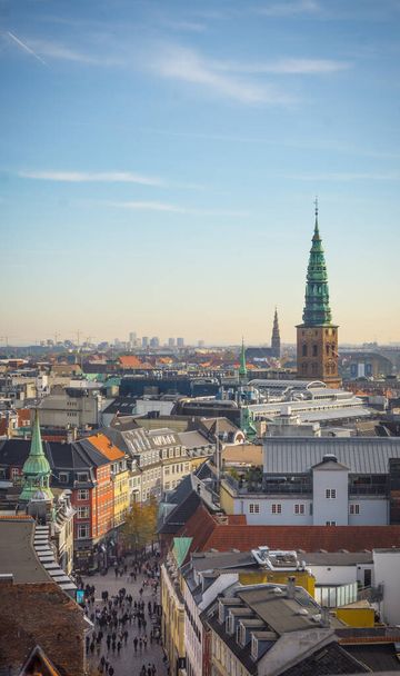 A vertical shot of cathedrals and residential buildings on a sunny day in Copenhagen, Denmark - Photo, Image