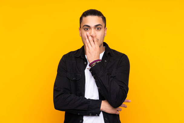 Asian handsome man isolated on yellow background frustrated and covering ears - Foto, Imagem