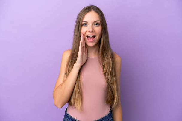 Young Lithuanian woman isolated on purple background with surprise and shocked facial expression - Zdjęcie, obraz