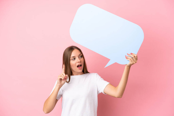Young Lithuanian woman isolated on pink background holding an empty speech bubble and thinking - Foto, imagen