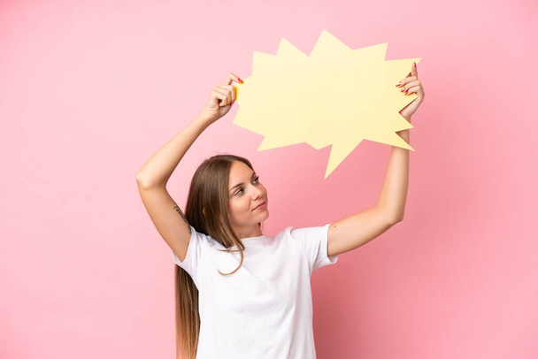 Young Lithuanian woman isolated on pink background holding an empty speech bubble - Photo, Image