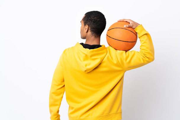 African American man over isolated white background playing basketball in back position - Fotoğraf, Görsel