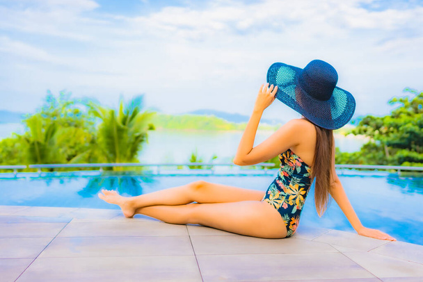 Портрет красива молода азіатка розслабляється посмішка відпочинок навколо відкритого басейну з видом на море для подорожей відпустка
 - Фото, зображення