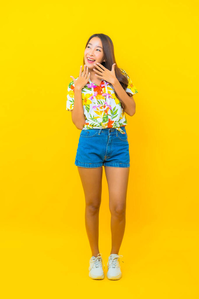 Portrait beautiful young asian woman wear colorful shirt on yellow background for sonkran festival in Thailand - Foto, Bild