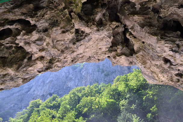 Toegang tot de grot Polovragi van Cheile OltetuluiPolovragi grot is gelegen in het Cpnii gebergte, aan de oevers van de Olte, op een hoogte van 670 m en 20 m hoog van de Oltet rivierbedding, op het grondgebied van de gemeente Polovragi - Foto, afbeelding