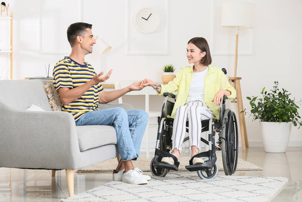 Young woman in wheelchair and her husband at home - Φωτογραφία, εικόνα
