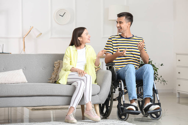 Young man in wheelchair and his wife at home - Φωτογραφία, εικόνα
