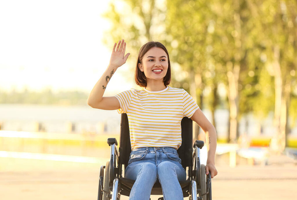 Mladá žena s tělesným postižením mává rukou venku - Fotografie, Obrázek