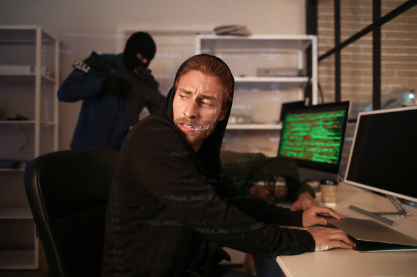 Assault team arresting hackers in dark room - Photo, Image