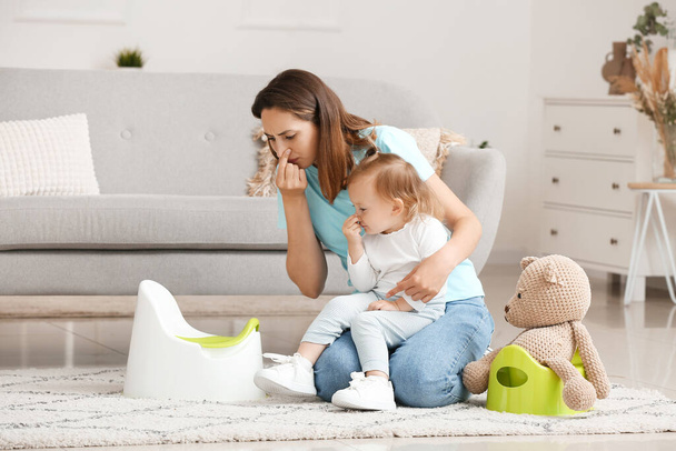 Mother potty training her little daughter at home - Photo, Image