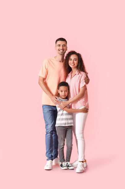 Happy interracial family on color background - Photo, Image