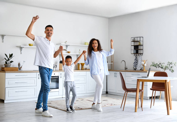 Happy interracial family dancing in kitchen - Fotografie, Obrázek