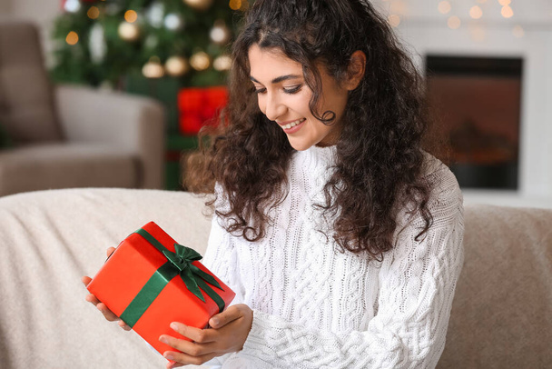 Happy woman with Christmas gift at home - Foto, Imagen