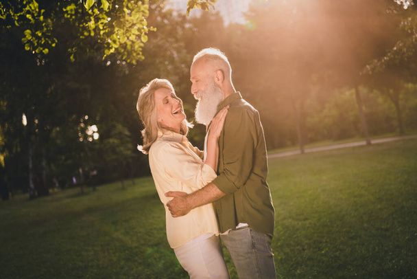 Profile photo of funky senior grey hair couple hug wear trend shirts outside spend free time - Foto, Imagen