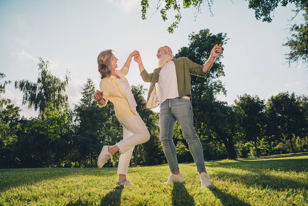 Full length photo of happy joyful old people feel young dance crazy together spring enjoy outside outdoors in park - Φωτογραφία, εικόνα