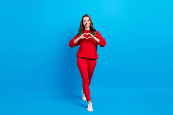 Full length body size view of pretty amorous cheerful girl going showing heart shape isolated over bright blue color background - Fotó, kép