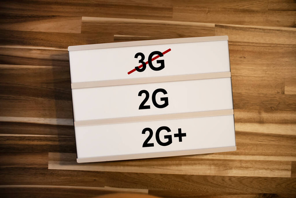 Lightbox or light box with german rules 3G, 2G and 2G+ plus on wooden table background - Foto, imagen
