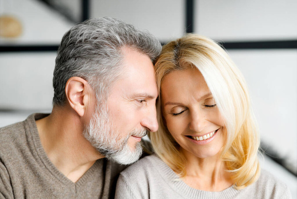 Headshot of romantic middle-aged couple indoors. - Foto, afbeelding