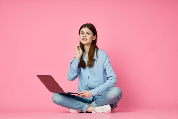 woman with laptop sitting on floor technology internet shopping pink background - Φωτογραφία, εικόνα