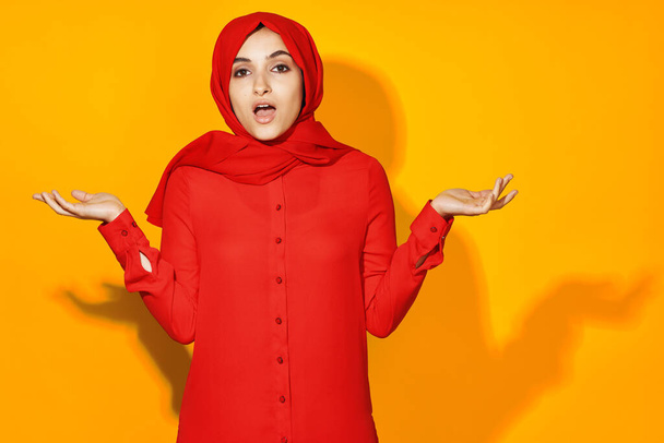 arab woman attractive eyes fun gesture hands yellow background - Foto, immagini