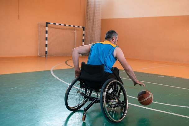 Close-up photo of a person with a disability playing basketball on the court. Selective focus. High-quality photo - Zdjęcie, obraz