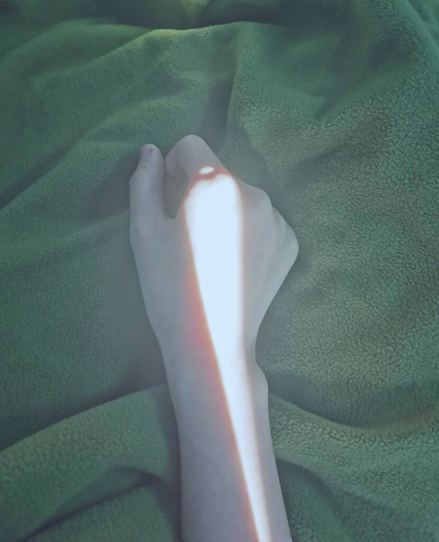 a closeup shot of a woman lying on a bed - Zdjęcie, obraz