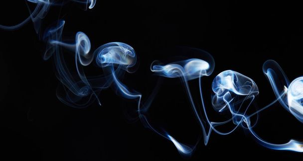 blue smoke on black background with abstract blur motion wave swirl . Wisp of Smoke. Cigarette smoke waves and clouds  texture - Foto, afbeelding