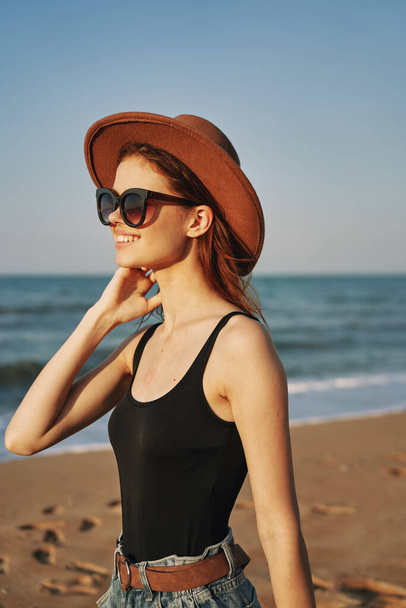 pretty woman in hat and sunglasses on the beach walk sun - Photo, Image