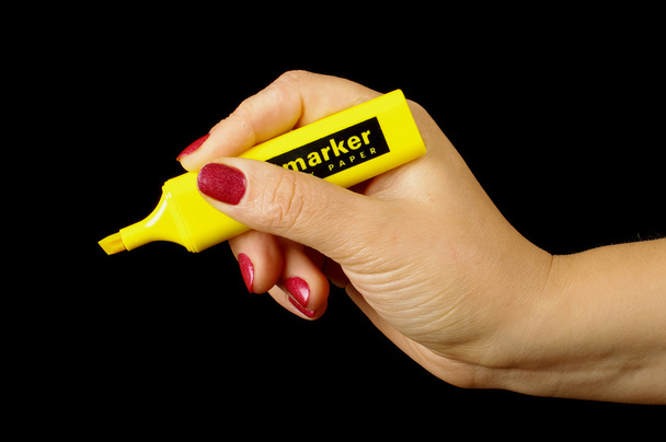 Female hand holding yellow marker low key - Photo, Image