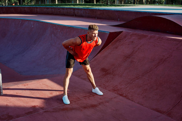 sports man doing exercises on the sports field fitness - Fotografie, Obrázek